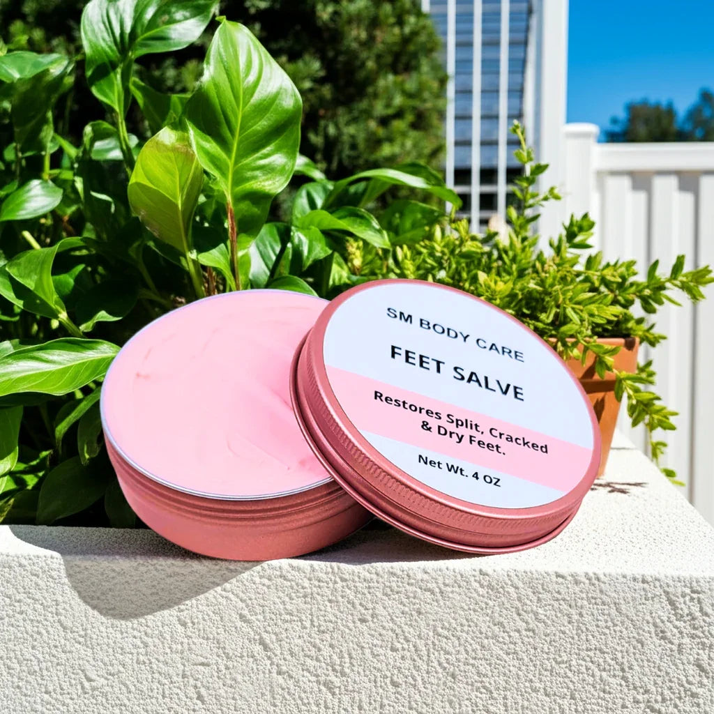 Pink jar of feet salve with a label on a ledge with greenery in the background