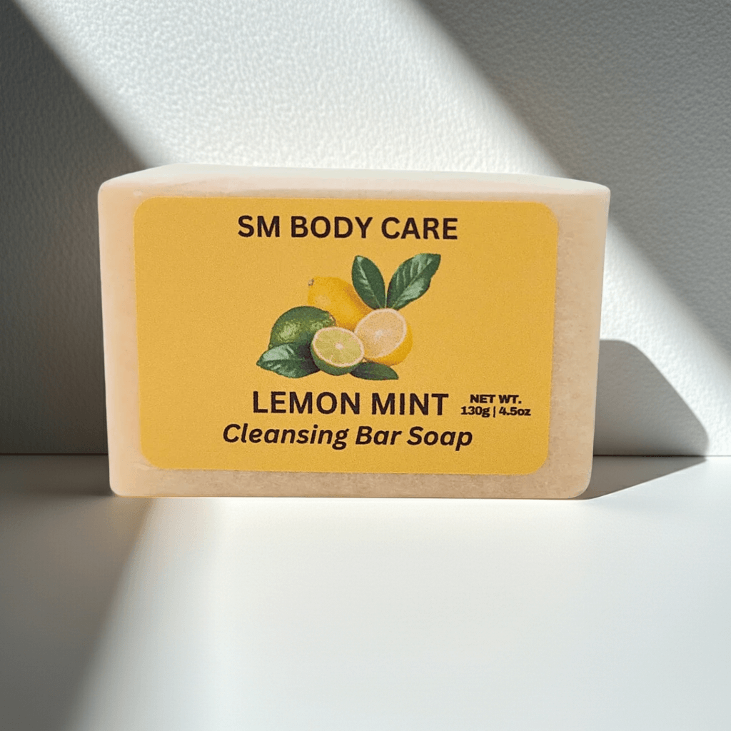 Bar of soap with a yellow label featuring lemon and mint graphics, labeled 'SM Body Care Lemon Mint Cleansing Bar Soap'.