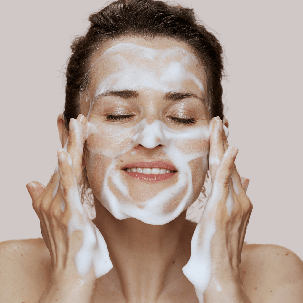 woman washing her face with the skin recovery foaming cleanser for dry skin 