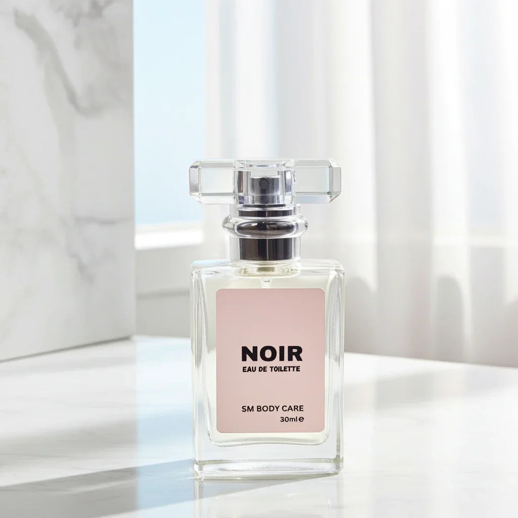 Perfume bottle labeled 'Noir' on a marble surface with a blurred background
