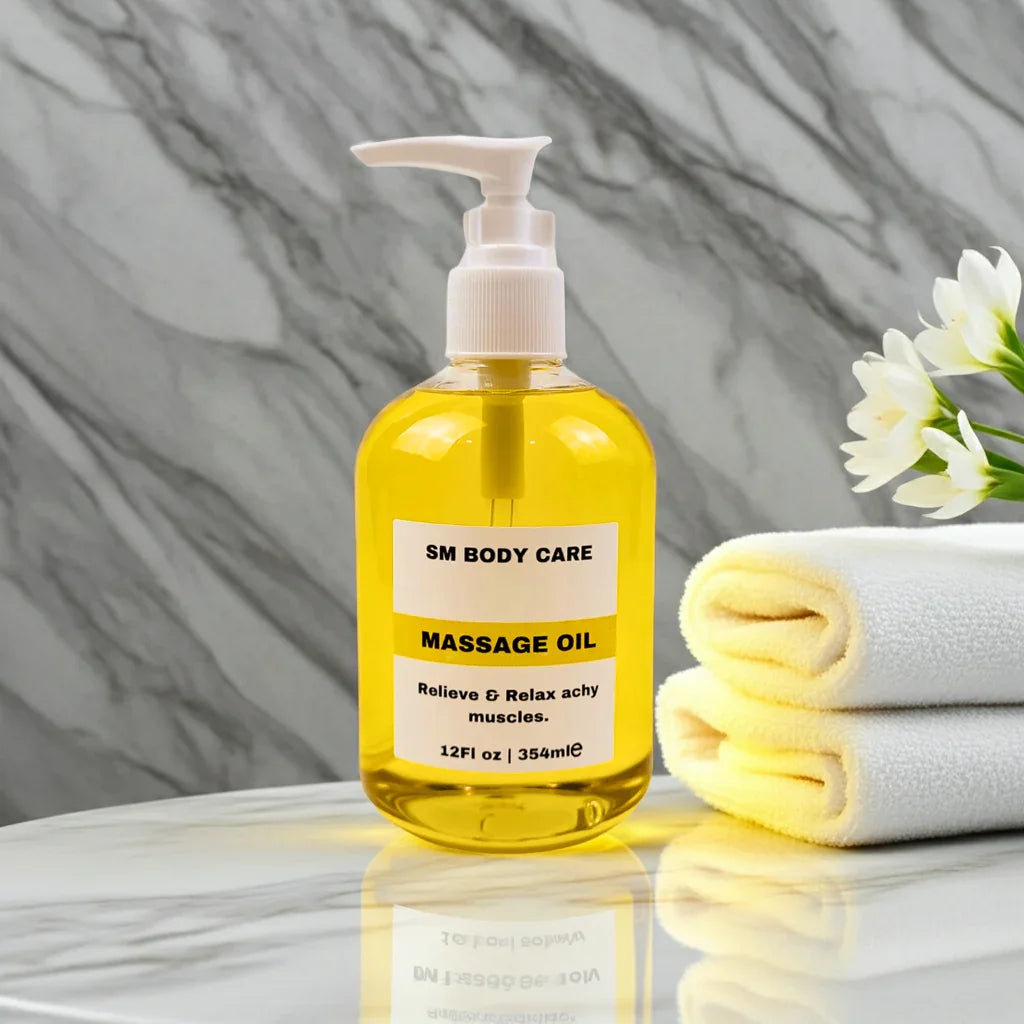 Yellow massage oil bottle with pump on a marble surface, next to a folded towel and flowers.