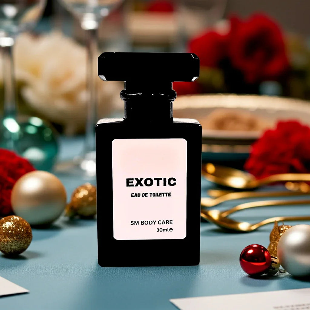 Black perfume bottle labeled 'Exotic' on a decorative table with flowers and ornaments.