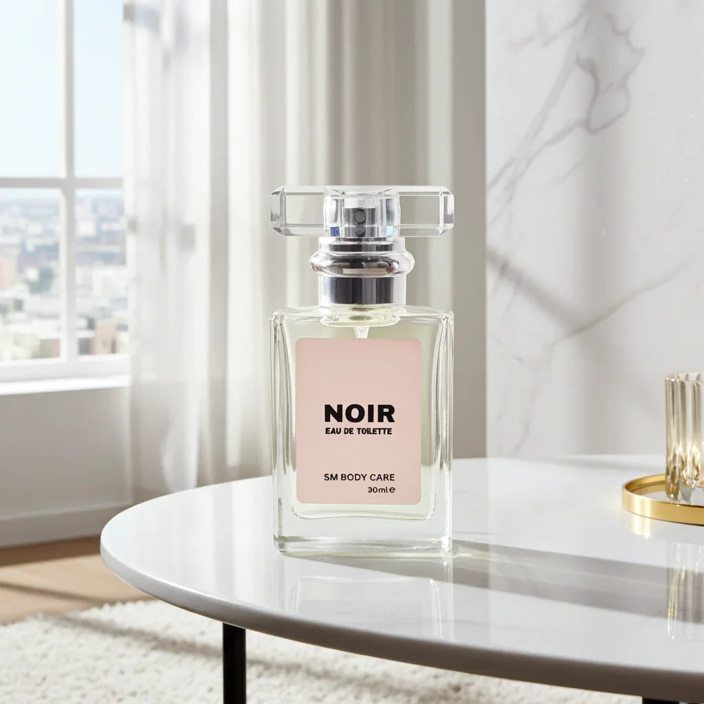 Perfume bottle labeled 'NOIR' on a table with a marble wall and window in the background